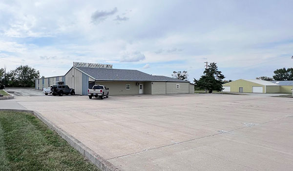 photo of 1. bulding with big parking lot.